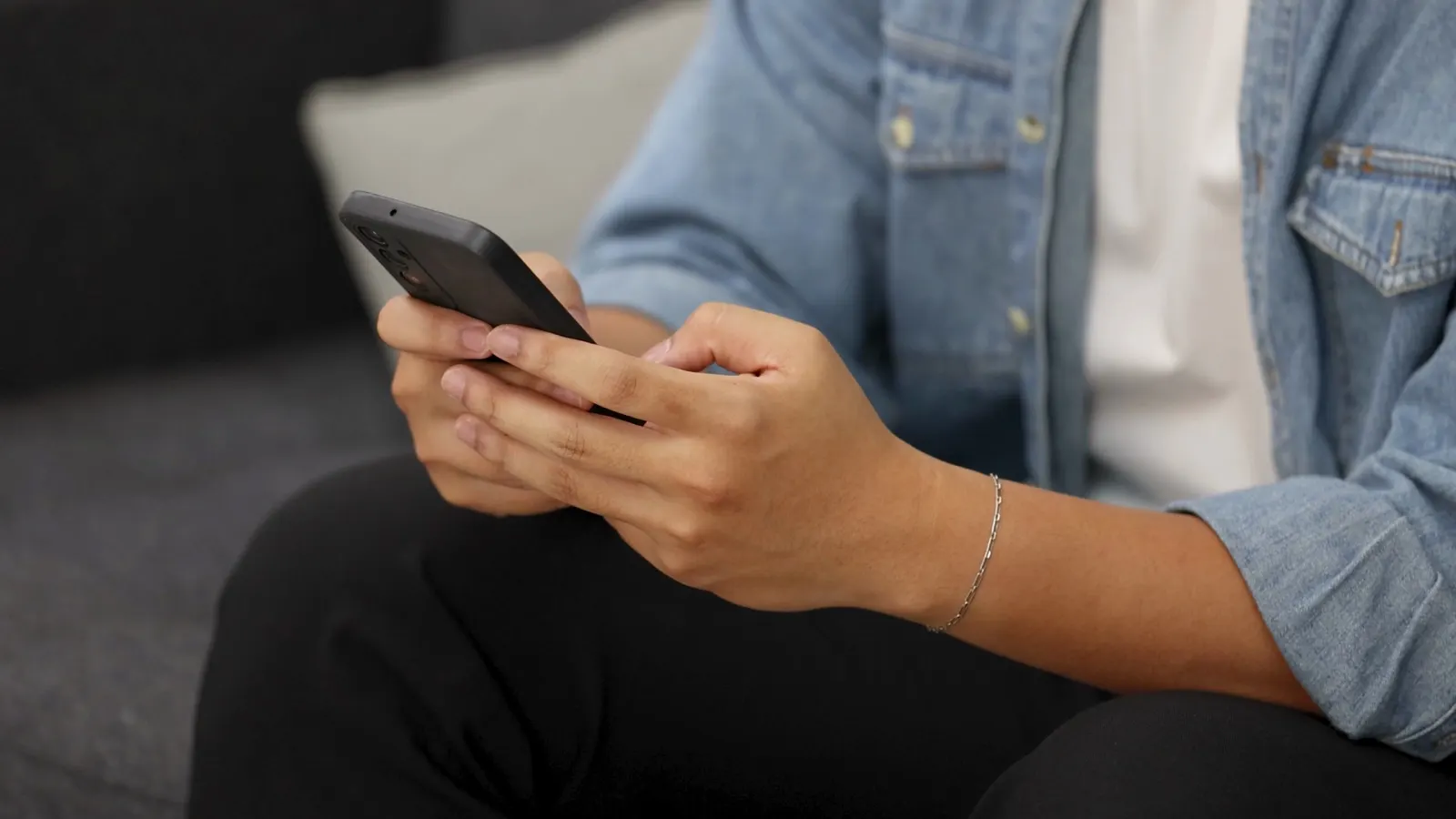 Persona revisando una conversación de WhatsApp en el móvil para un peritaje informático